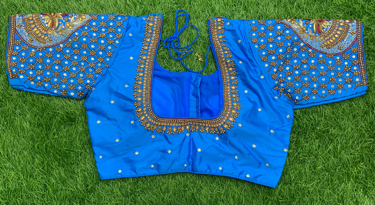 Blue fairoza red colour thread work with golden zari n white stone handwork blouse