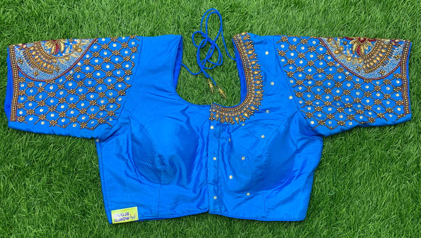 Blue fairoza red colour thread work with golden zari n white stone handwork blouse